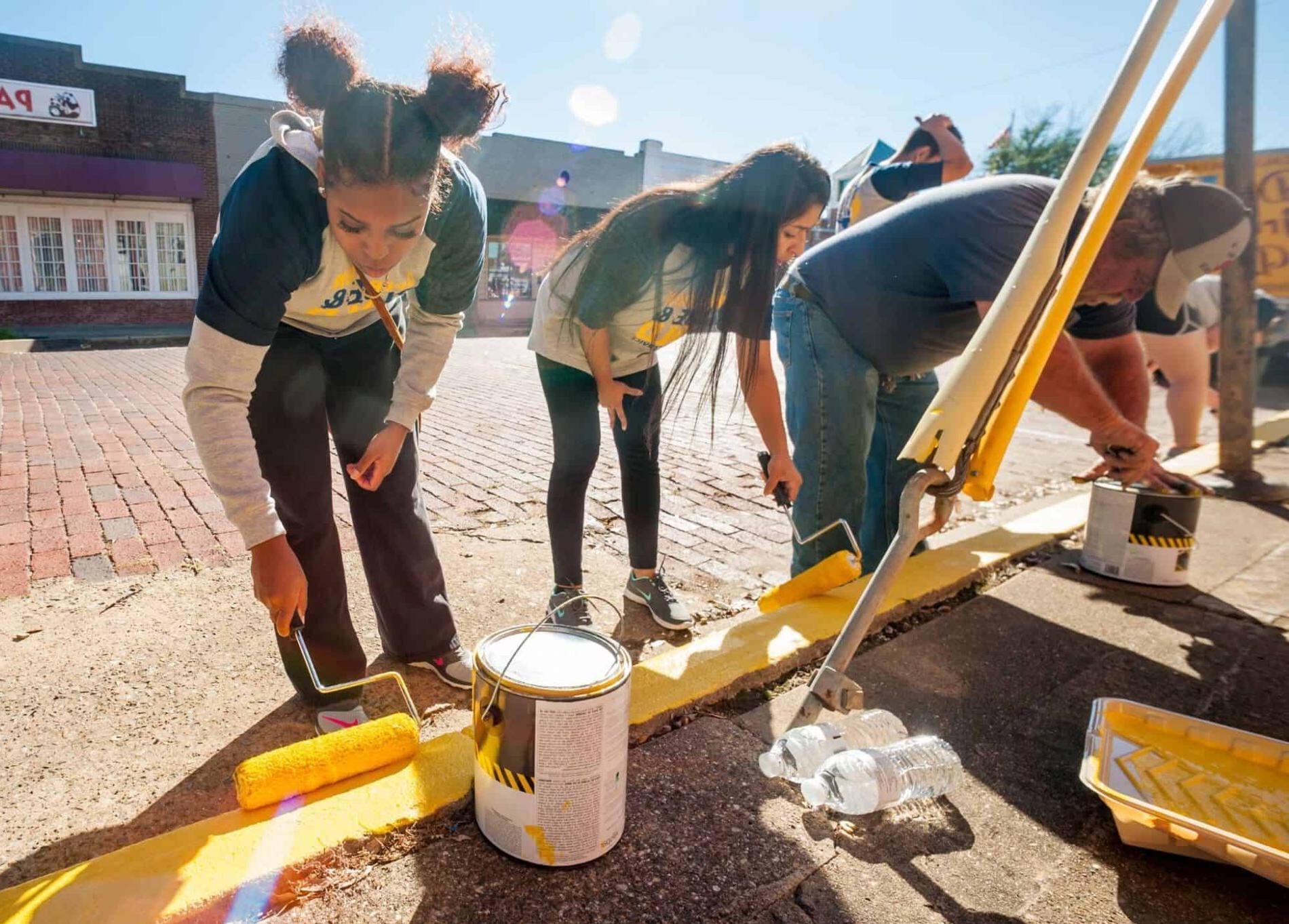 Students painting foot path